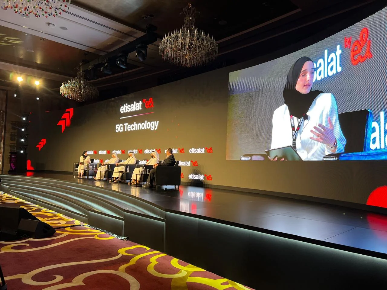 Panel discussion on a wide e& event stage